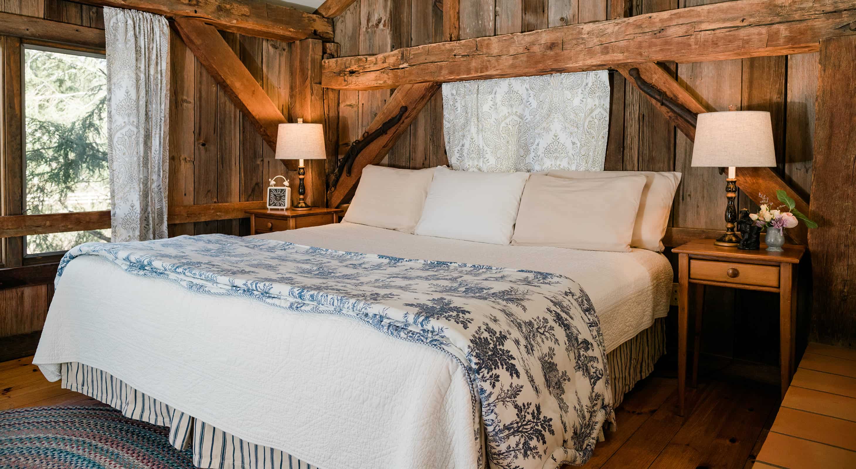 bedroom with wooden walls and bed