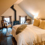 Chair by fireplace in dormer sitting area