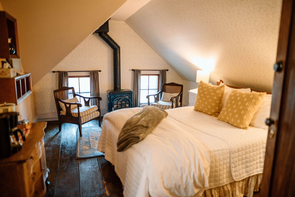 Chair by fireplace in dormer sitting area