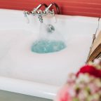 Book holder and bouquet above warm bathtub