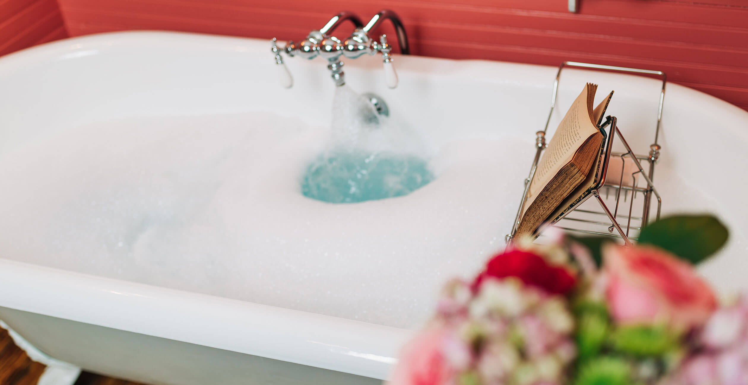 Book holder and bouquet above warm bathtub