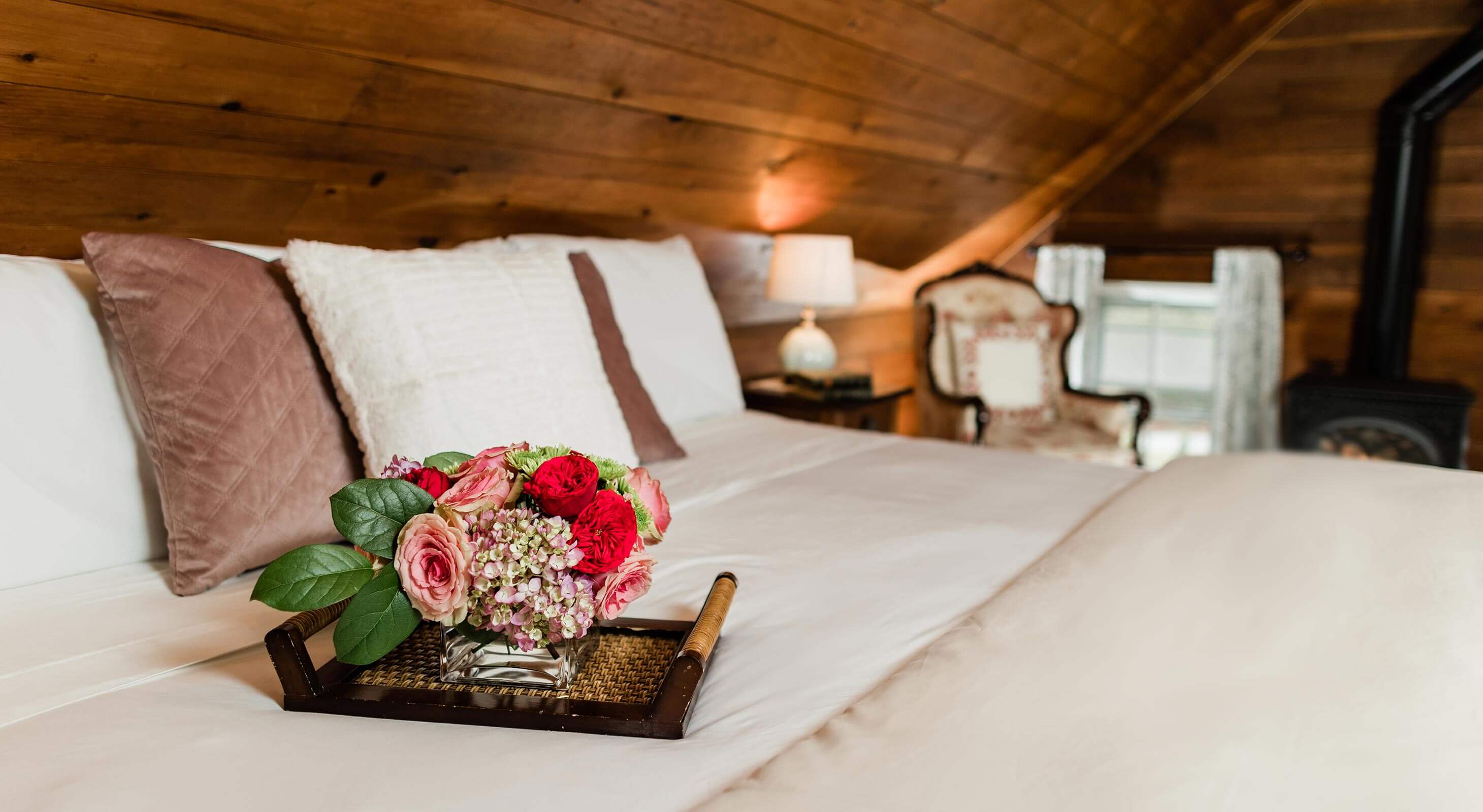 Tray of flowers on bed in the Cherry Room - Cabins near Banner Elk