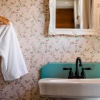 Bathrobe hanging by sink in the Elizabeth Gray Vining room's bathroom