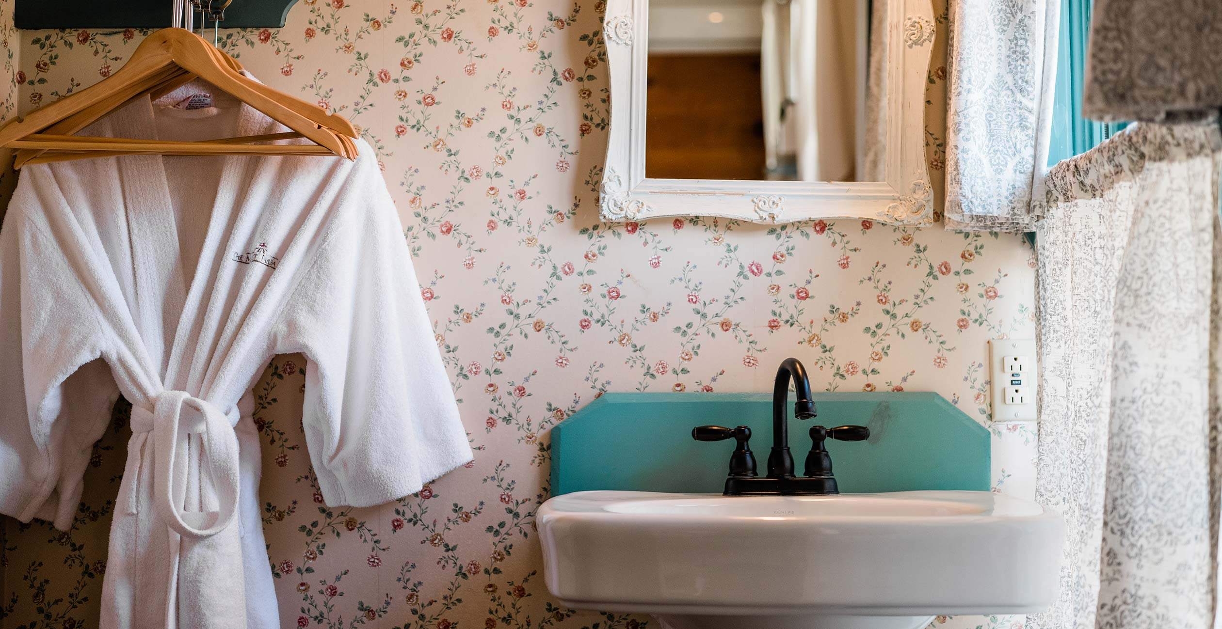 Bathrobe hanging by sink in the Elizabeth Gray Vining room's bathroom