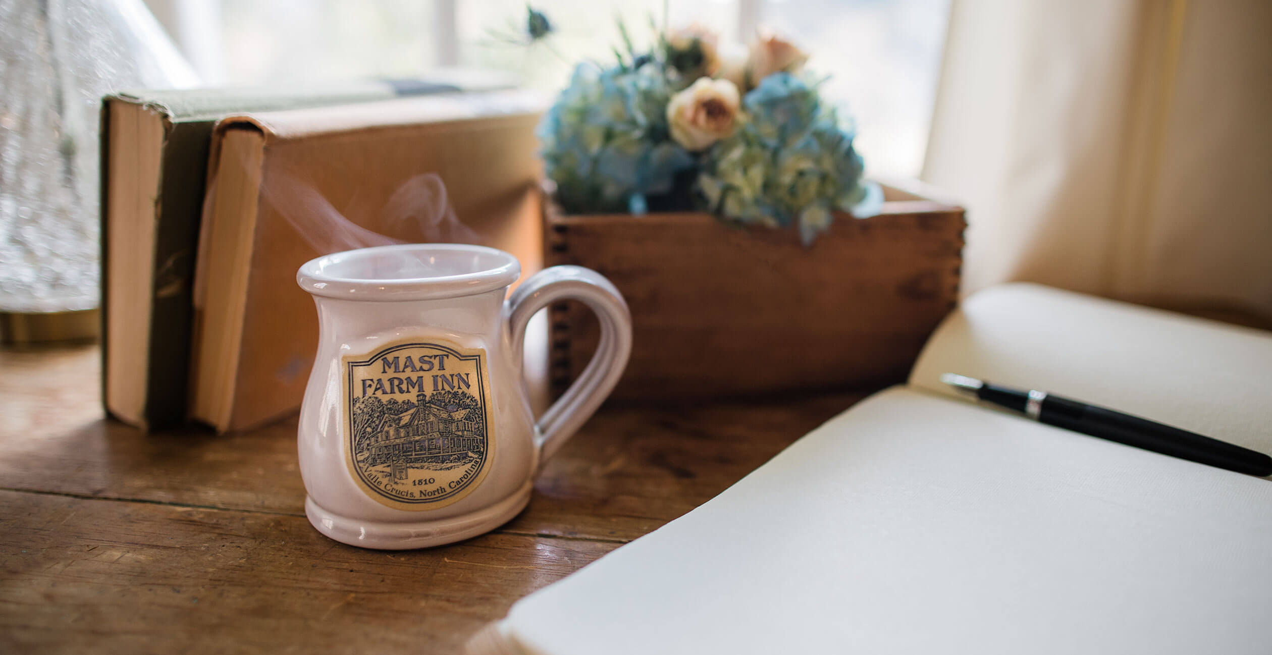 Coffee cup next to open journal