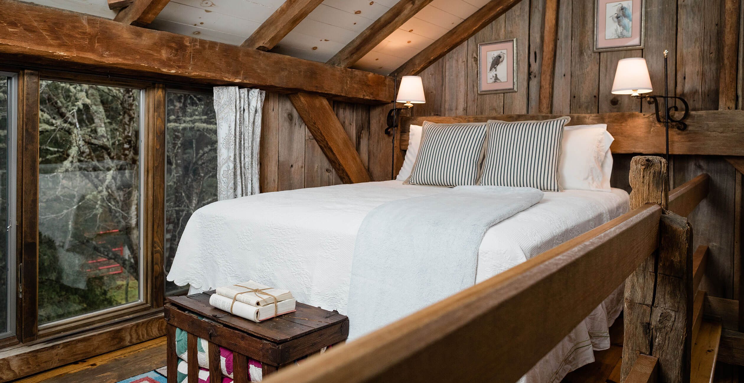 Bed with striped pillows next to window