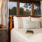 Bed with books on it next to window