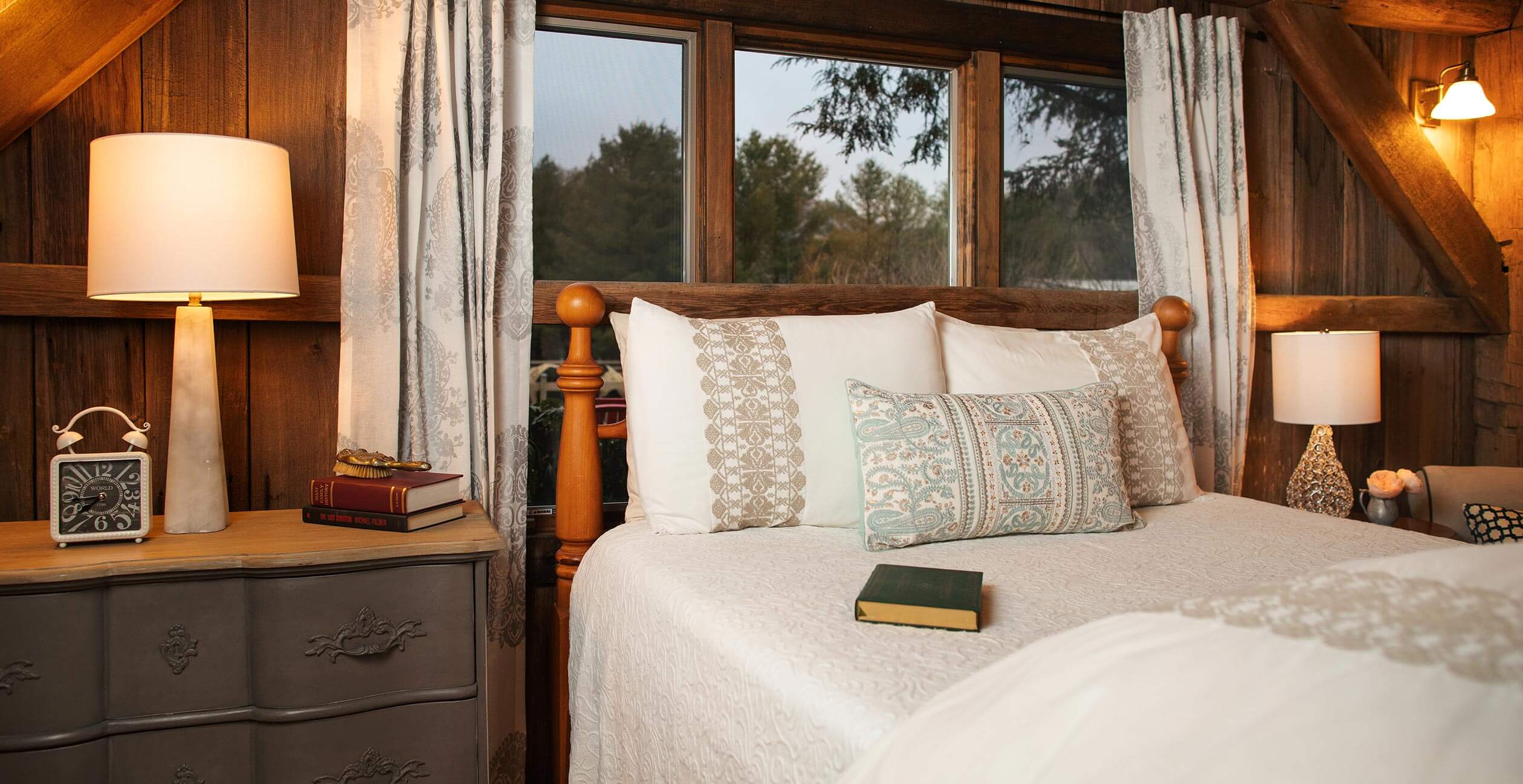Bed with books on it next to window