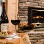 Wine and charcuterie on a small table by the fire