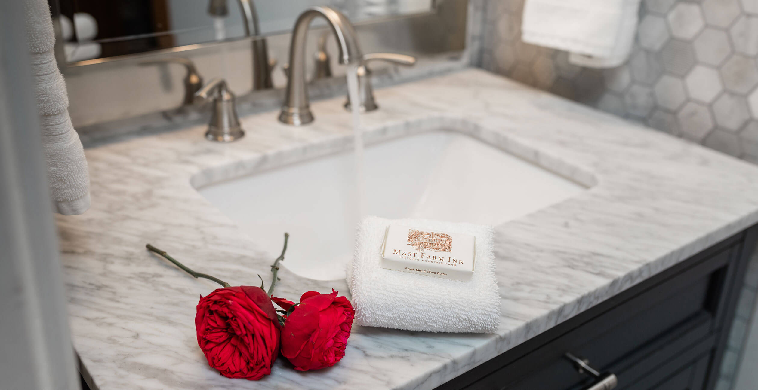 Soap, towel, and roses in the bathroom of the Raspberry Hill cabin