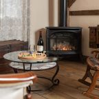 Board game and wine in sitting area with fireplace in the Woodwork Shop