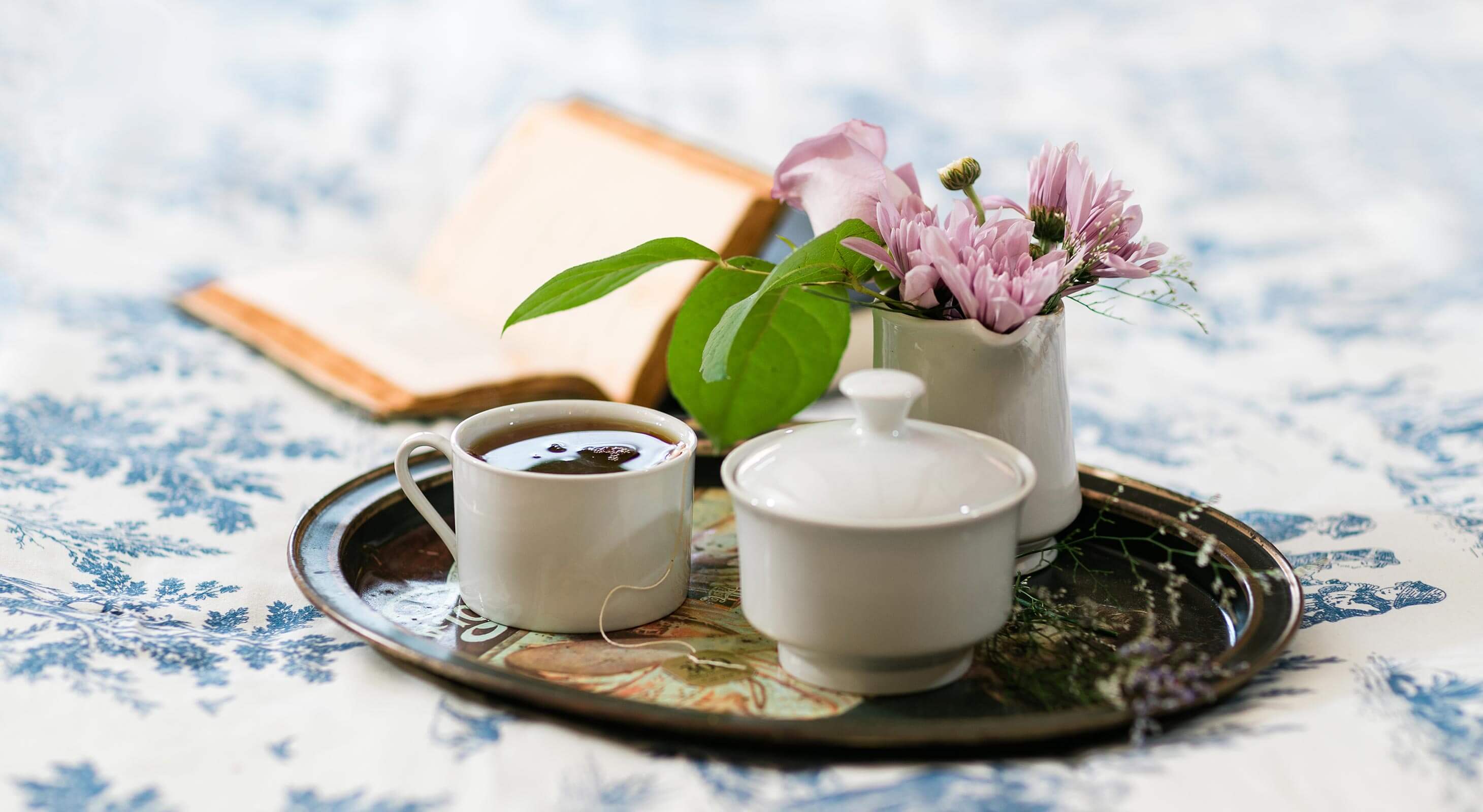 Tea tray with flowers and book