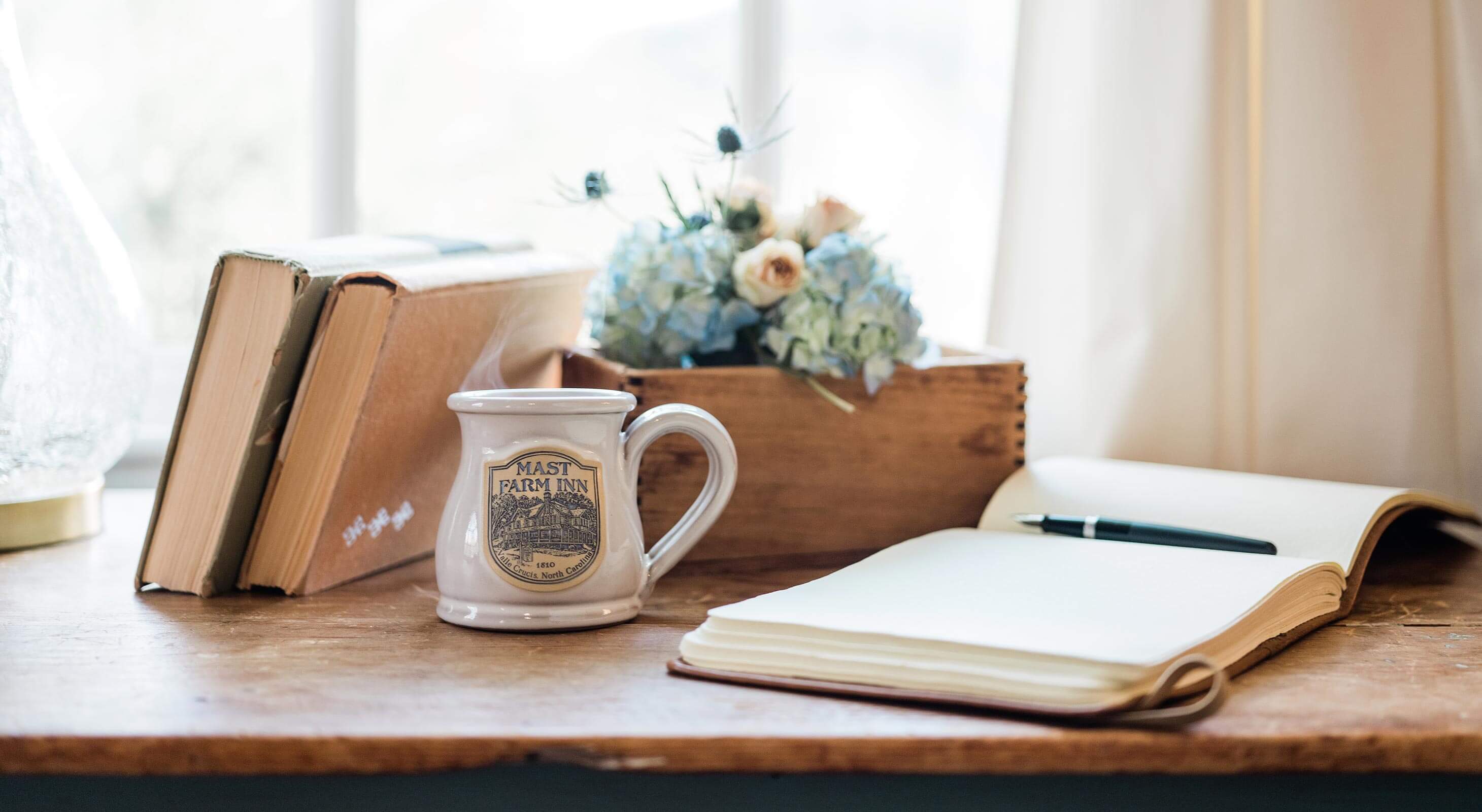 Open book with coffee on desk