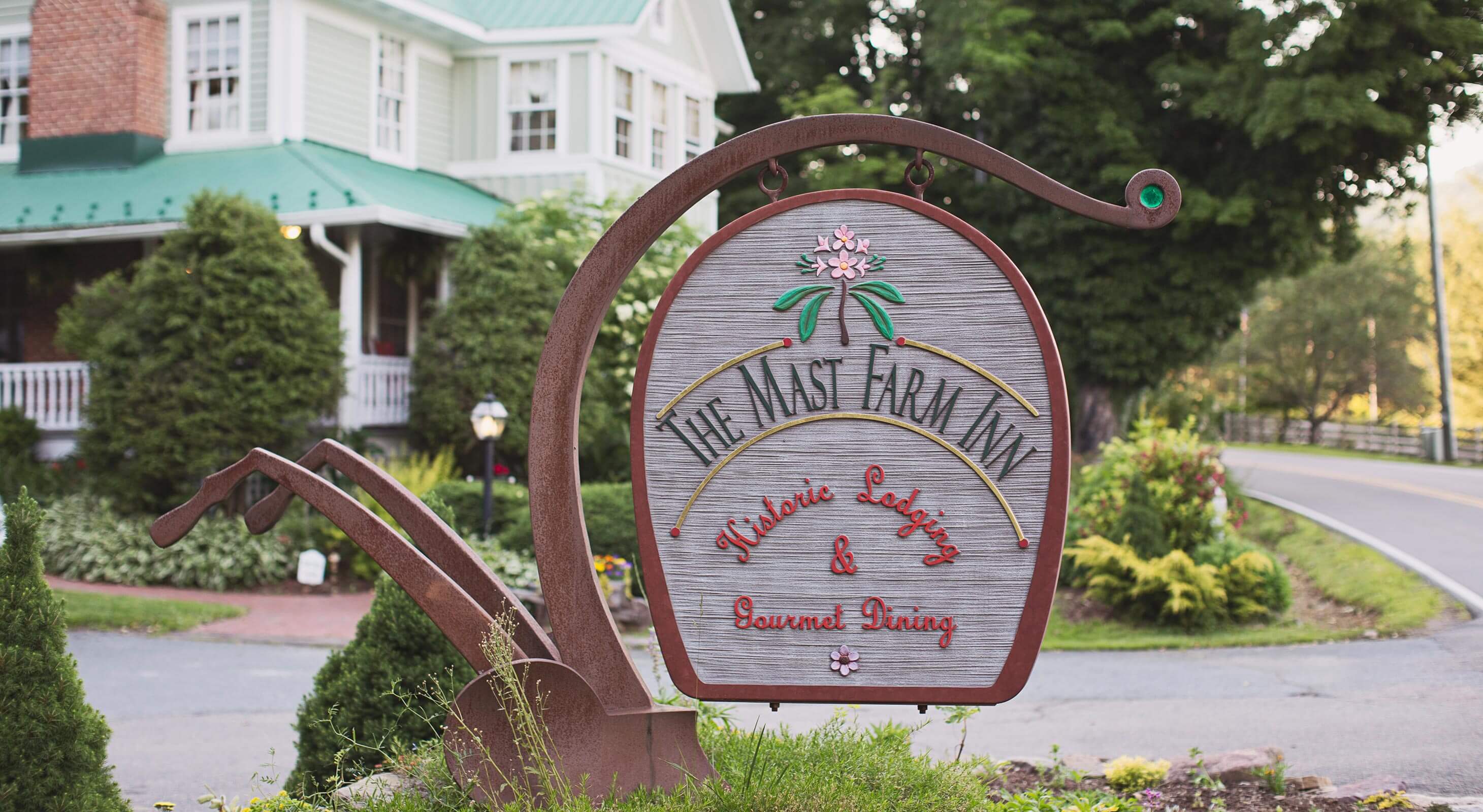 Sign and exterior of the Mast Farm Inn