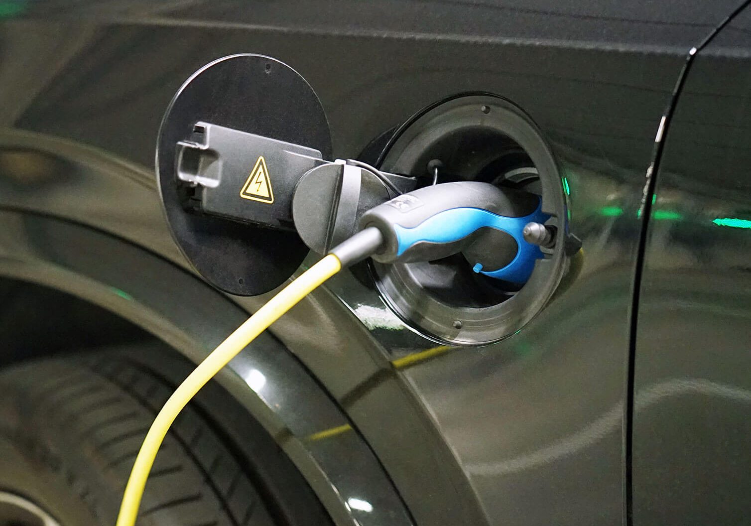 Electric car charger plugged into car
