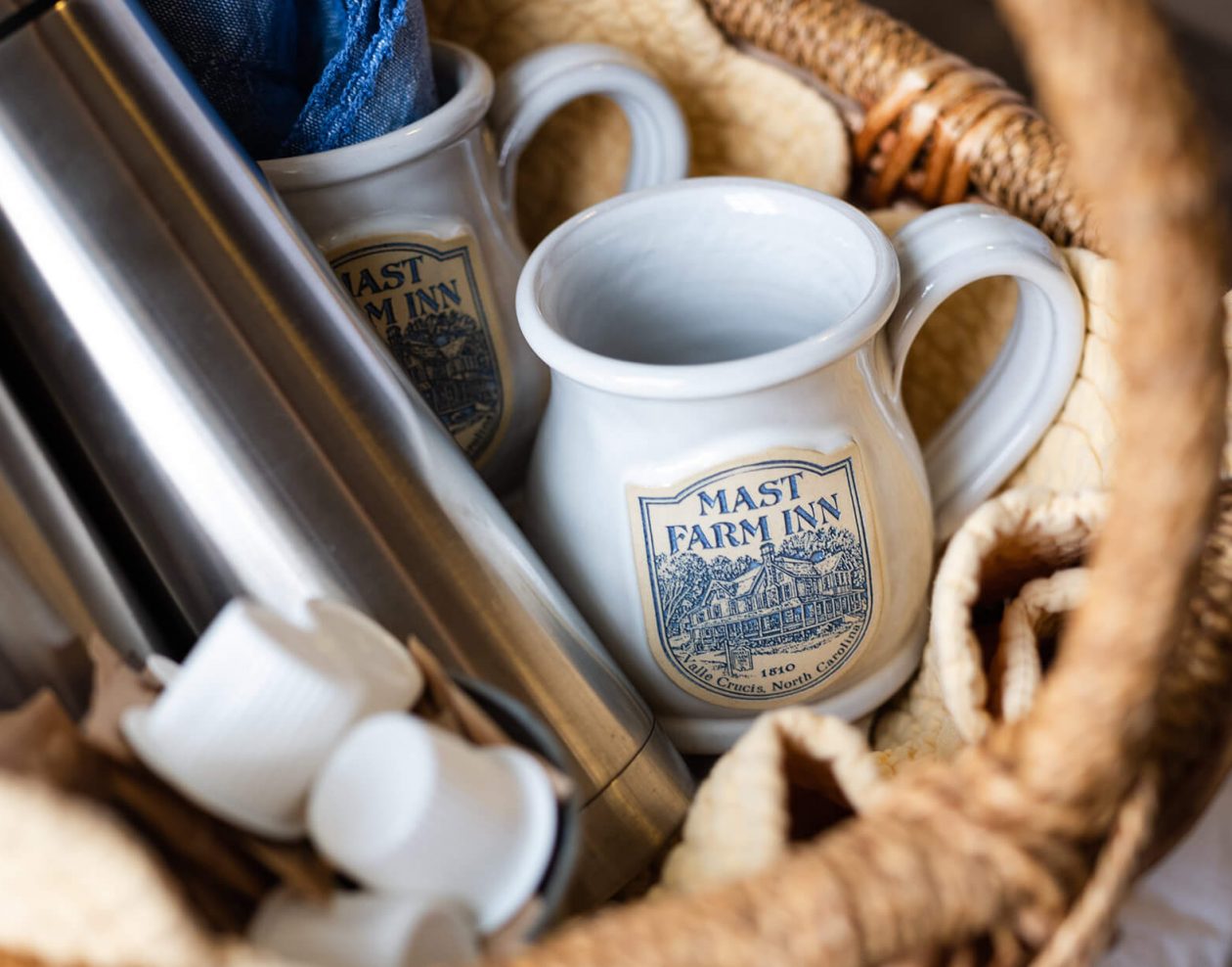 Basket with coffee, creamer and mugs