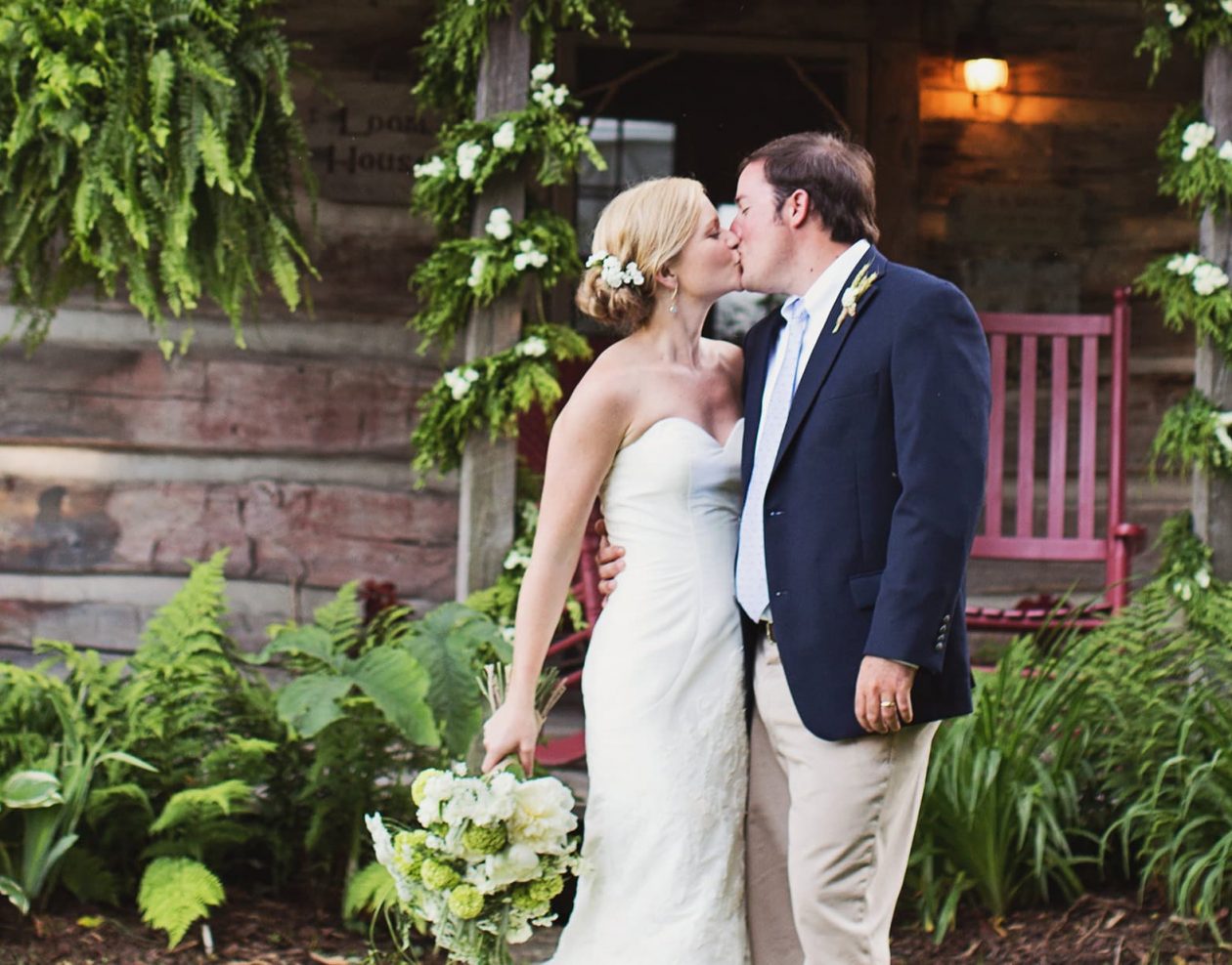 Wedding couple kissing in front of the Loom House