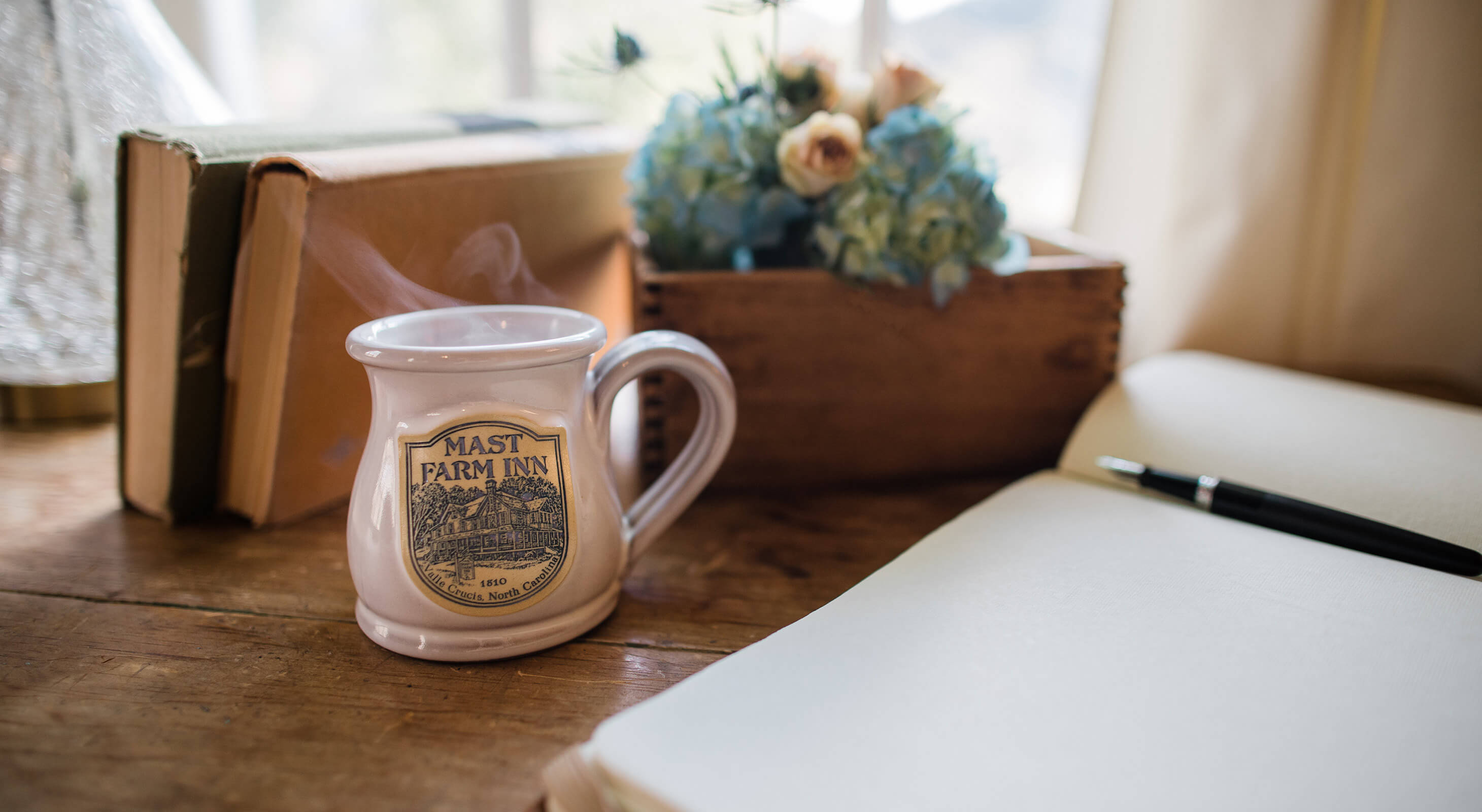 Coffee cup and notebook on a desk