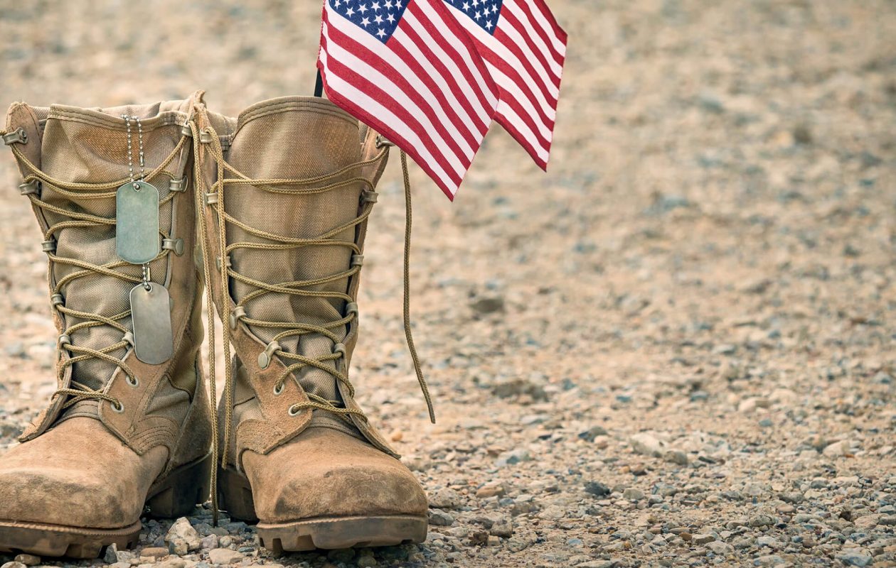 Combat boots with dog tags and American flags