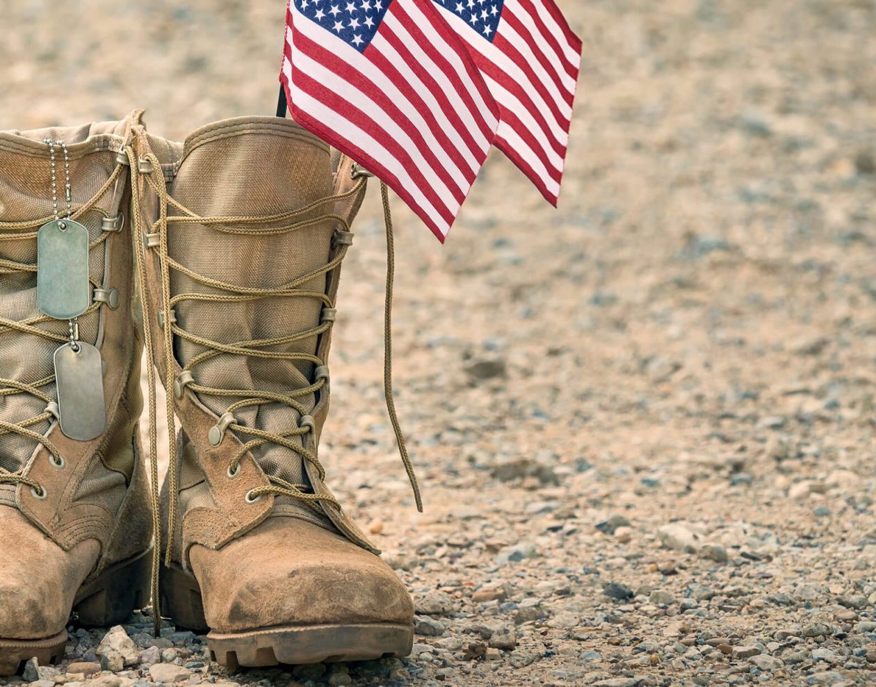 Combat boots with dog tags and American flags