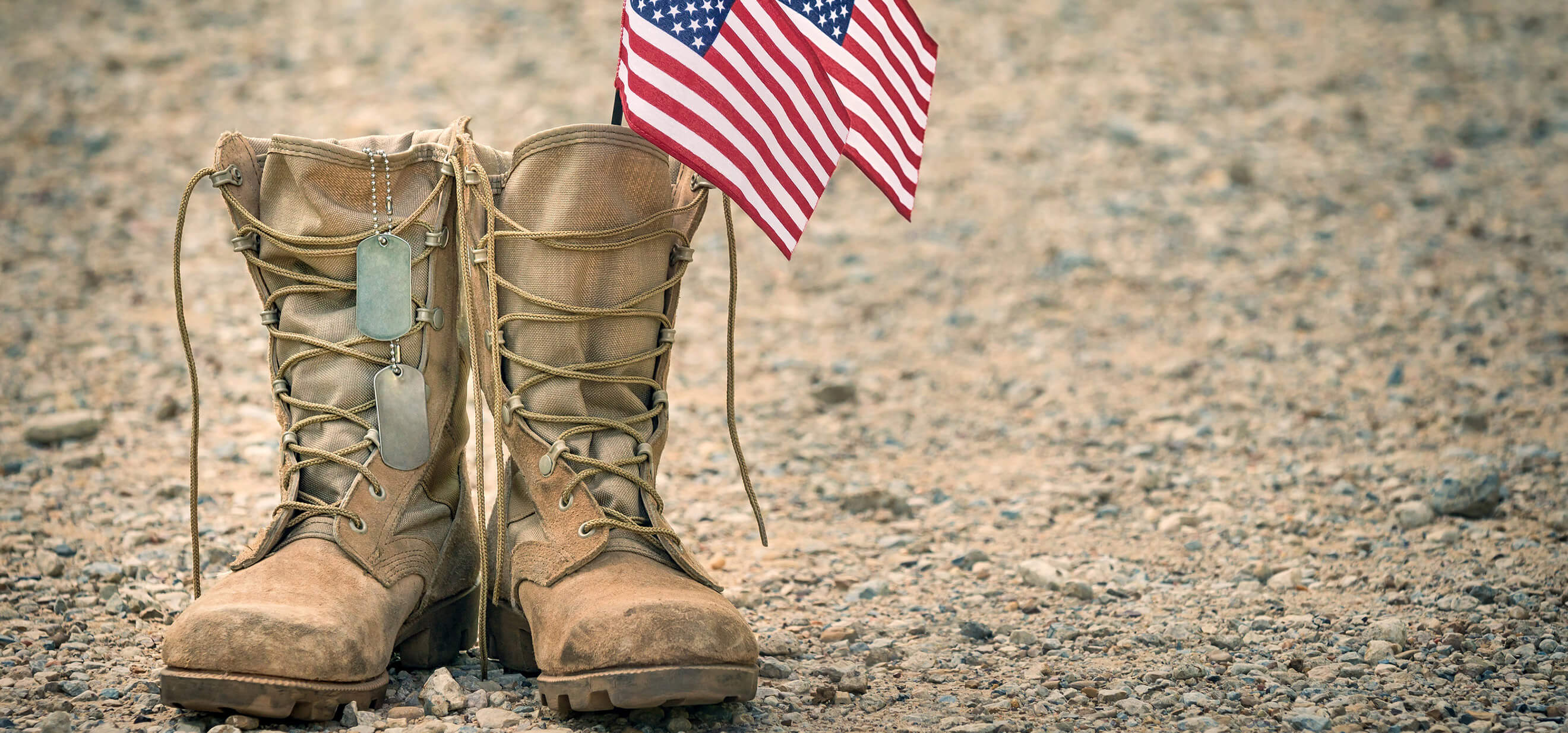 Combat boots with dog tags and American flags