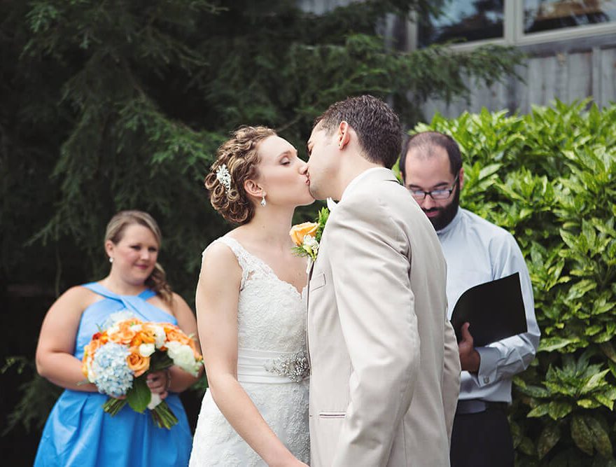 Bride and Groom kiss at their wedding ceremony