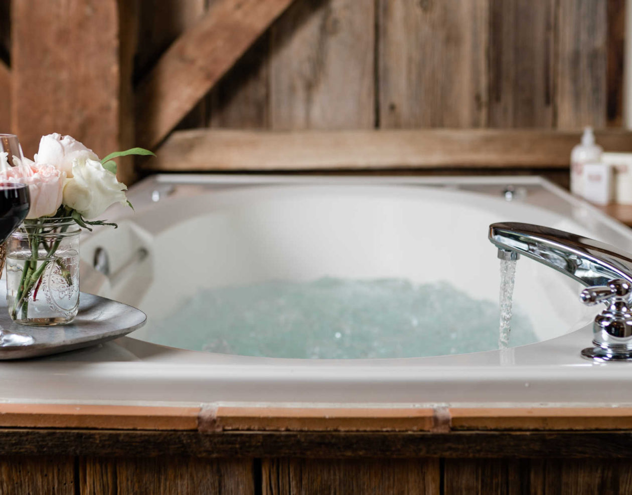 Relaxing bath with a cup of wine at The Mast Farm Inn
