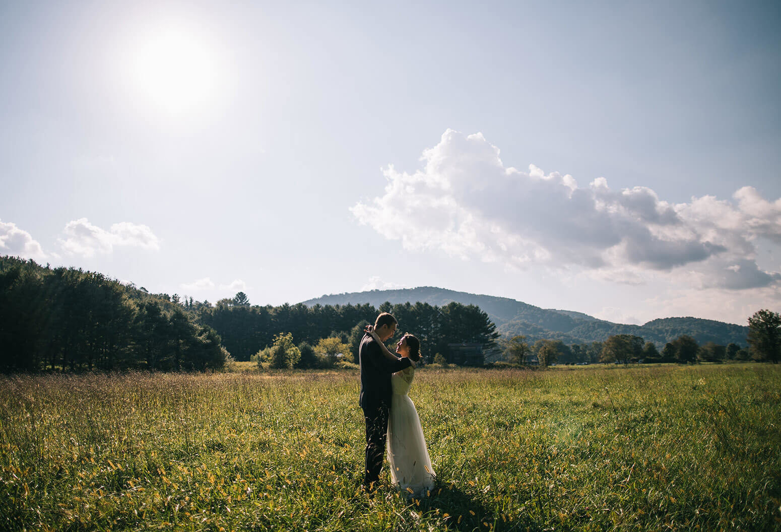Couple kissing in a sunny meadow