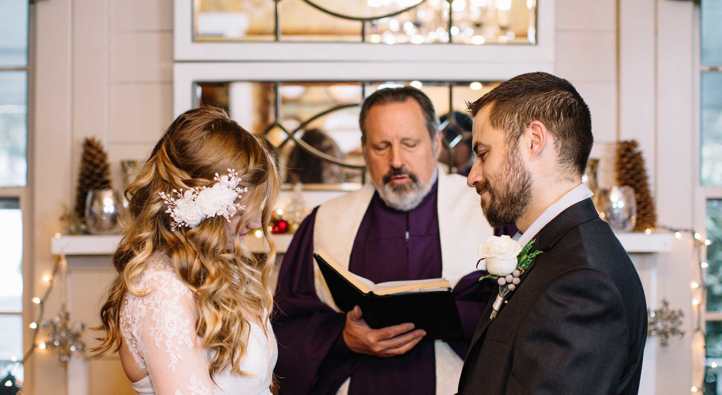 Wedding ceremony in front of ornate fireplace