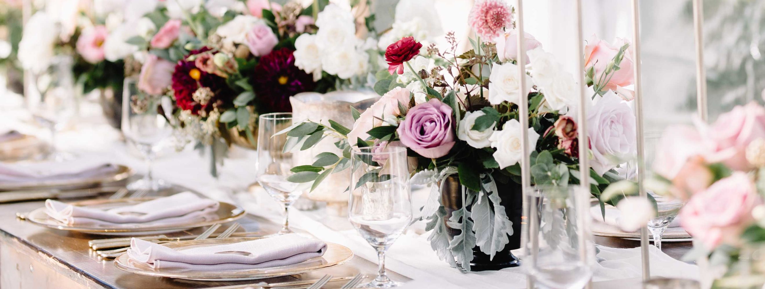 Beautiful pink and burgundy flowers and table settings