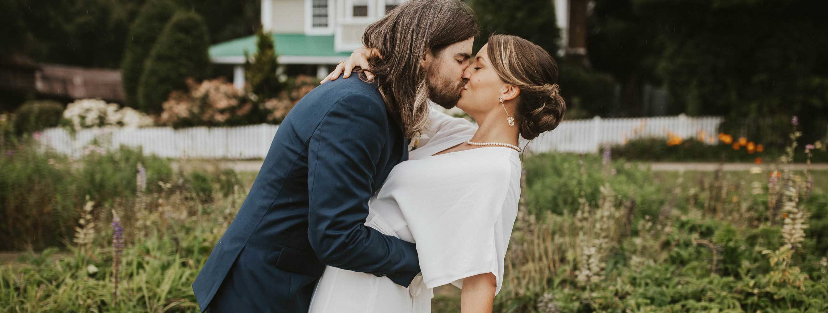 Groom kissing bride in front of the inn