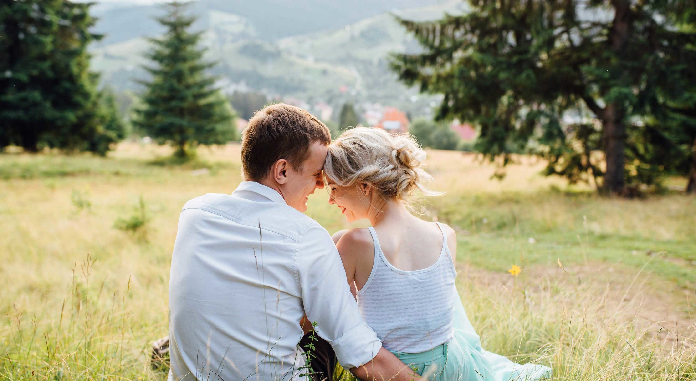 Romantic couple sitting in a meadow