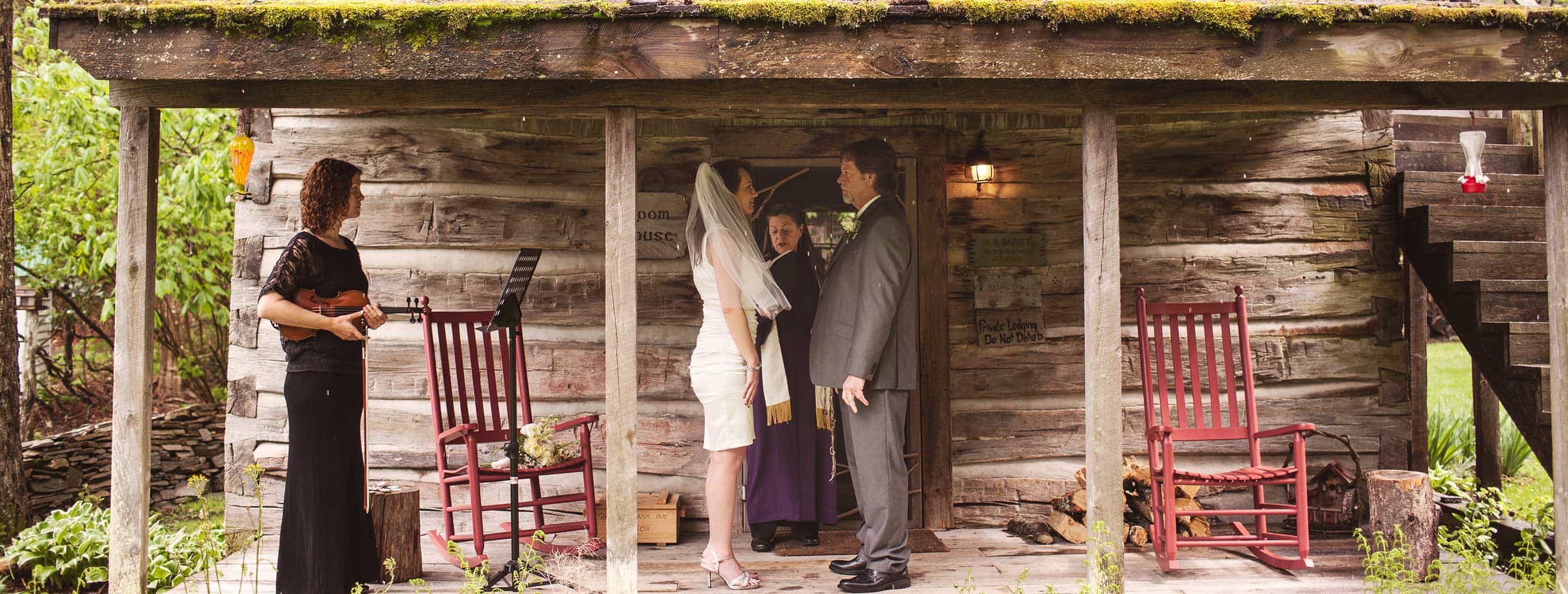 Couple getting married on the porch of a vintage farm house