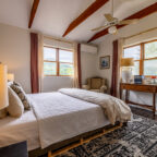 Bed with books on it next to window