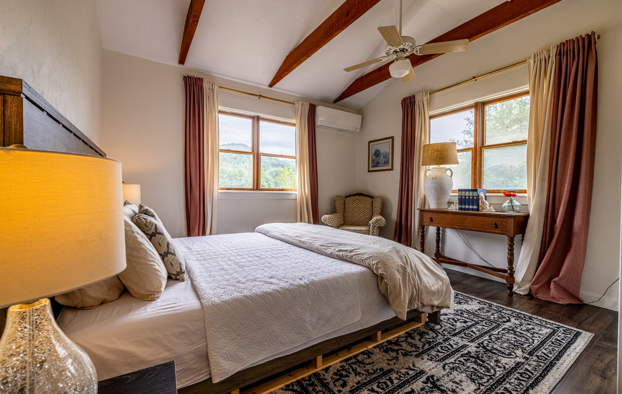 Bed with books on it next to window